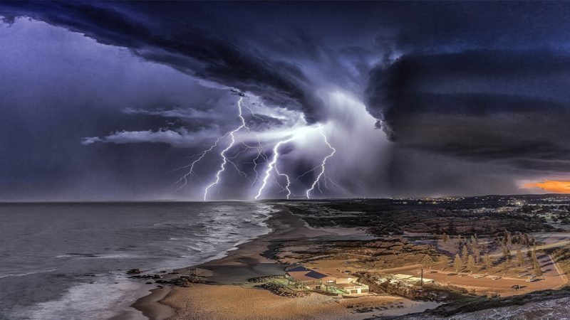 Breathtaking photos show lightning strikes illuminate Australia’s coastline as the sun sets during wild and stormy weather