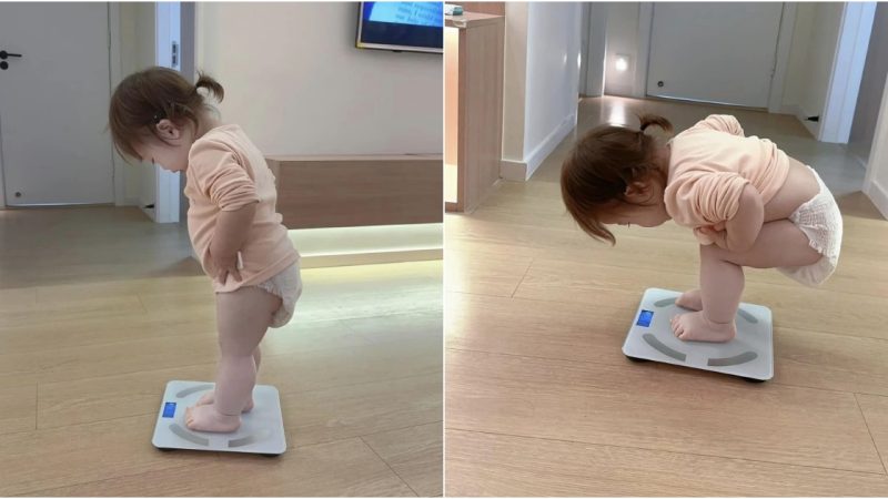 The Irresistibly Cute Moment When a Baby Playfully Takes a Step onto the Scale Has Everyone Bursting into Laughter.